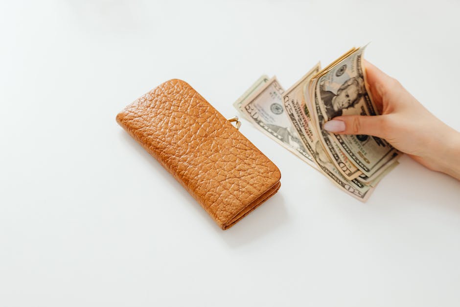 An image of a hand holding money, representing increased IRA rates and the growth of retirement savings