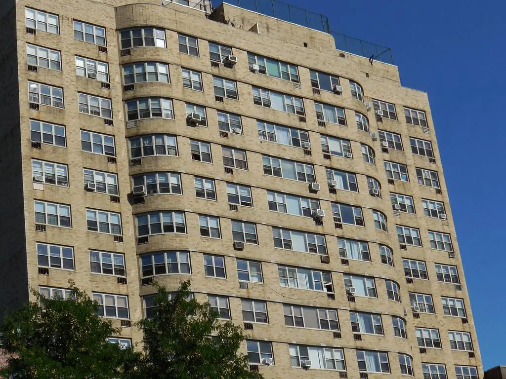 A modern apartment building representing real estate investments