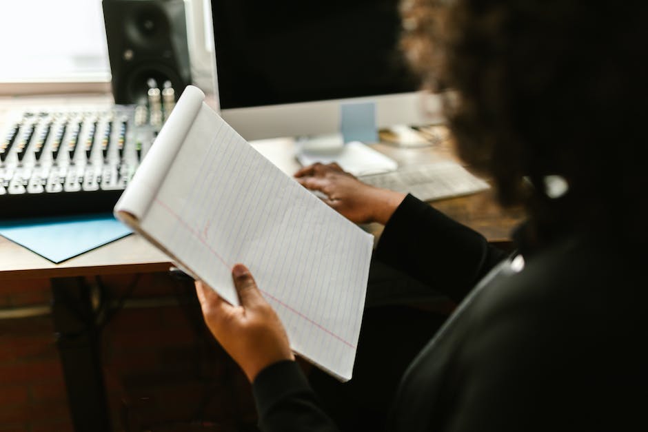 A person holding a notepad with the words IRA Transfer Process written on it.