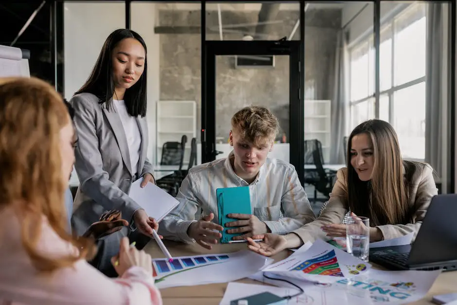 Image of a smiling group of small business employees gathered around a table discussing retirement savings with a financial advisor.